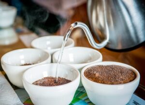 Pitcher pouring Greenwell Farms 100% Kona Coffee