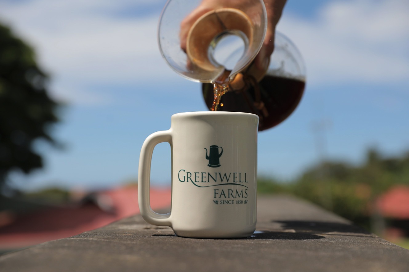 Pouring 100% Kona Coffee into a Greenwell Farms mug